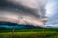 Storm clouds over a green grass field Royalty Free Stock Photo