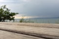 Storm clouds over the sea and the city.Old wooden bench against the background of the sea