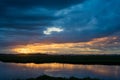 Storm clouds over the water and sunset over the lake Royalty Free Stock Photo