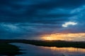 Storm clouds over the water and sunset over the lake Royalty Free Stock Photo