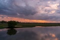 Storm clouds over the water and sunset over the lake Royalty Free Stock Photo