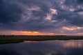 Storm clouds over the water and sunset over the lake Royalty Free Stock Photo