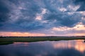 Storm clouds over the water and sunset over the lake Royalty Free Stock Photo