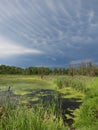 Storm clouds trail over wetlands in FingerLakes NYS Royalty Free Stock Photo