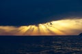 Storm clouds and raging waves in the sea.