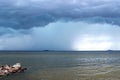 Storm clouds, rain and lightning over the sea Royalty Free Stock Photo