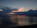 Storm clouds with rain over the lake at sunset Royalty Free Stock Photo