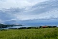 Storm clouds running across the sky against the background of the sea and green hills on coast. Scenic view to Adriatic sea Royalty Free Stock Photo