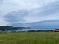 Storm clouds running across the sky against the background of the sea and green hills on coast. Scenic view to Adriatic sea Royalty Free Stock Photo