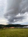 Storm clouds running across the sky against the background of the sea and green hills on coast. Scenic view to Adriatic sea Royalty Free Stock Photo