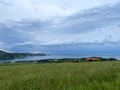 Storm clouds running across the sky against the background of the sea and green hills on coast. Scenic view to Adriatic sea Royalty Free Stock Photo