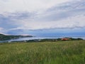 Storm clouds running across the sky against the background of the sea and green hills on coast. Scenic view to Adriatic sea Royalty Free Stock Photo