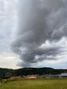 Storm clouds running across the sky against the background of the sea and green hills on coast. Scenic view to Adriatic sea Royalty Free Stock Photo