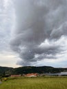 Storm clouds running across the sky against the background of the sea and green hills on coast. Scenic view to Adriatic sea Royalty Free Stock Photo