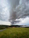 Storm clouds running across the sky against the background of the sea and green hills on coast. Scenic view to Adriatic sea Royalty Free Stock Photo