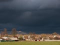 Storm clouds thunderclouds over the village in spring Royalty Free Stock Photo