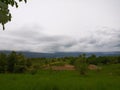 Storm coming on the farm with pasture and animals grazing, dairy cows and corn crop