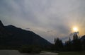 Storm dark clouds over mountain river valley with grass and rocks Royalty Free Stock Photo