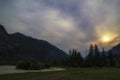 Storm dark clouds over mountain river valley with grass and rocks Royalty Free Stock Photo