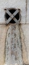 A storm drain outlet set in a wall Royalty Free Stock Photo
