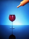 Storm in a glass of red wine on a blue background Royalty Free Stock Photo