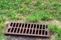 Storm hatch sewage with a rusty grill.