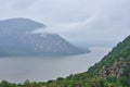 Storm King Mountain, seen from Hudson Highlands State Park across the Hudson River on a foggy and rainy day
