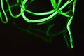 Toxic green lime lighting with a specific pattern. Woven filaments, cable, wires with outgoing light. Neon electroluminescent wire