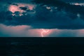 Stormy clouds with lightning over ocean