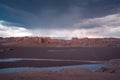 Storm with lots of rain coming to the Lut desert, Iran, in the golden hour. Stormclouds gather while the horizon glows