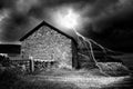 The Storm. Night time shot of stone built farmhouse with added Lightning. Royalty Free Stock Photo