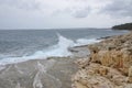 Storm in the ocean, big waves hitting the rocks. Big splashes from the waves hitting the rocks. Royalty Free Stock Photo