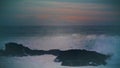 Storm ocean hitting coastal rocks at dark skyline. Breathtaking evening seascape