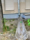 Storm pipes from a high-rise building of brown and metal color. Pipes for rainwater runoff.