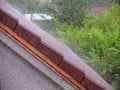 Storm rain on the roof of the house Royalty Free Stock Photo