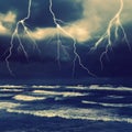 Storm by the sea. Heavy dark clouds with sparkling lightning Royalty Free Stock Photo