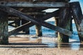 Storm sea waves under wooden pier in dramatic background wallpaper design. Seascape with running splashing sea waves Royalty Free Stock Photo