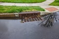 Storm sewer designed to carry excessive surface water from impervious surfaces such as paved roads into the drainage system. Royalty Free Stock Photo