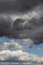 Storm sky. Dark grey and white big cumulus clouds against blue sky background, cloud texture, thunderstorm Royalty Free Stock Photo