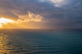 Storm with thick dark clouds approaching the coast at sunrise. Light beams are coming from thew sun behind the dark clouds, There Royalty Free Stock Photo