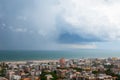 Storm with tornado in Rimini, Italy. Picturesque landscape view with sea, clouds, cityscape and whirlwind.