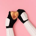 Storm trooper hands are offering heart covered in raw meat on pink background