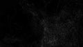A storm of white particles on a black background, particle tornado. Wave of particles. Abstract background for