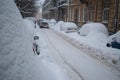 Winter, lots of snow. Cars are covered with snow. Street. Storm