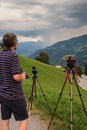 Stormchaser is watching and photographing a thunderstorm in the mountains Royalty Free Stock Photo