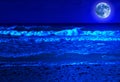 Stormy beach at midnight with a full moon Royalty Free Stock Photo