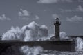 Stormy big waves crashing against old lighthouse Royalty Free Stock Photo