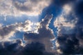 Stormy blue sky with white and dark clouds and sun rays breaking through Royalty Free Stock Photo