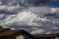 Stormy clouds in the sky, over the roofs of some homes - photograph