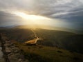 Stormy clouds with sun rays above mountains Royalty Free Stock Photo